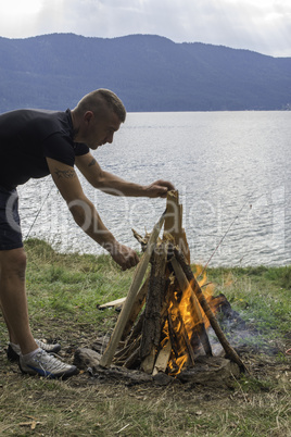 Boy who light fire in a forest