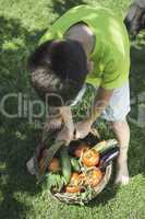 Child and basket with vegetables.