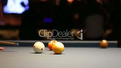Playing Eight-ball pool billiards in a bar