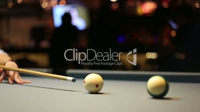 Playing Eight-ball pool billiards in a bar
