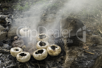 Mushrooms grilled on a coals in nature