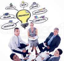 Composite image of business team sitting in circle and discussin