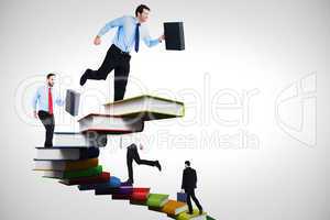 Composite image of businessman walking while holding briefcase