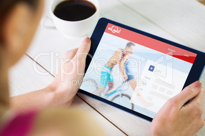 Composite image of woman using tablet pc