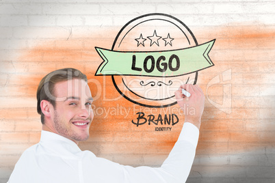 Composite image of cheerful businessman writing with marker