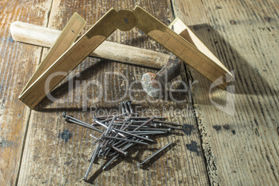 Vintage hammer, nails and wooden centimeter