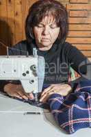 Woman sewing on a sewing machine