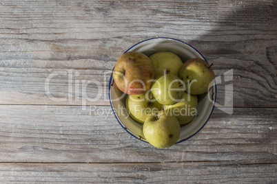 Apples in vintage metal cup