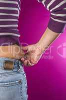 Woman with jeans shows her belly.