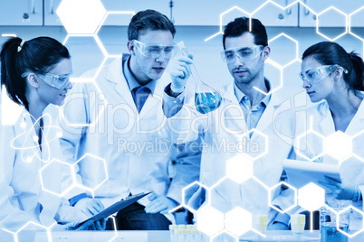 Composite image of scientists working on an experiment at the la