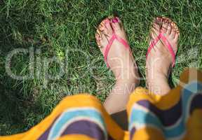 Feet on green meadow