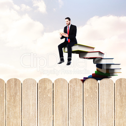 Composite image of businessman reading