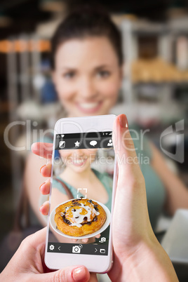 Composite image of hand holding smartphone