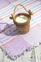 Vintage wooden cup of milk