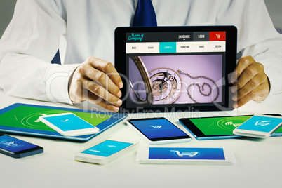 Composite image of businessman showing tablet pc