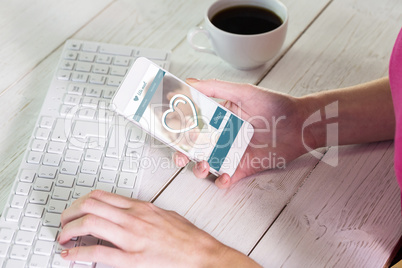 Composite image of woman using smartphone at work