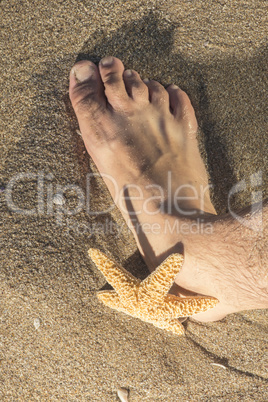 Feet in the waves on the beach