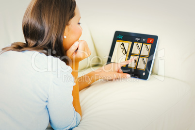 Composite image of woman touching her digital tablet