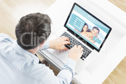 Composite image of man using laptop