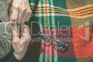 Elderly woman buttoning his vest
