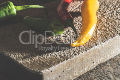 Hot peppers on wooden cutting board