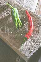 Red hot peppers on wooden  cutting board