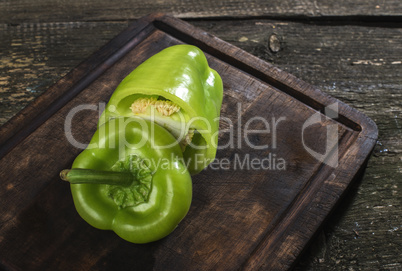 Cut green pepper on wood