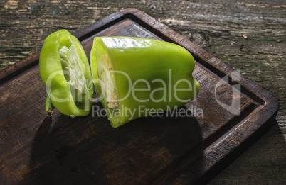 Cut green pepper on wood