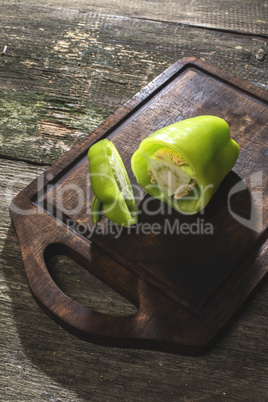 Cut green pepper on wood