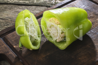 Cut green pepper on wood