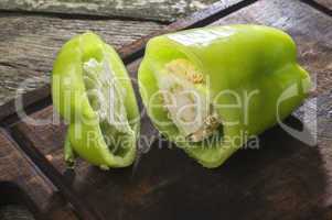 Cut green pepper on wood