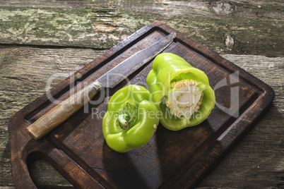 Cut green pepper on wood