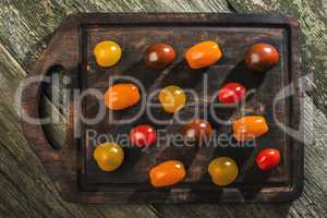 Variety of cherry tomatoes on wood