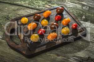 Variety of cherry tomatoes on wood