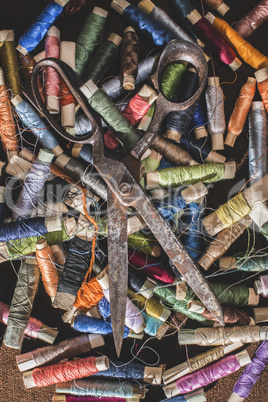 Old vintage scissors on spools of thread