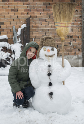 Snowman and child in the yard