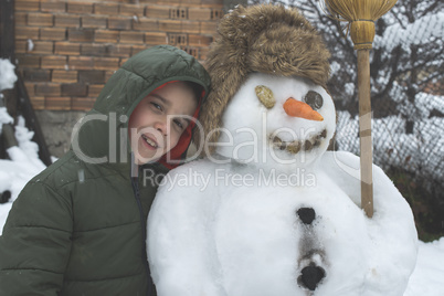 Snowman and child in the yard