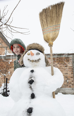 Snowman and child in the yard