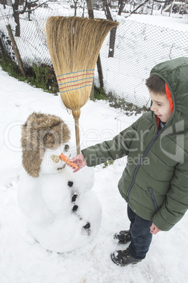 Snowman and child in the yard