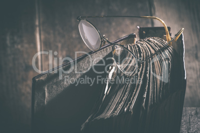 Old vintage round glasses and book