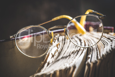 Old vintage round glasses and book