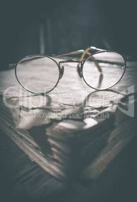 Old vintage round glasses and book