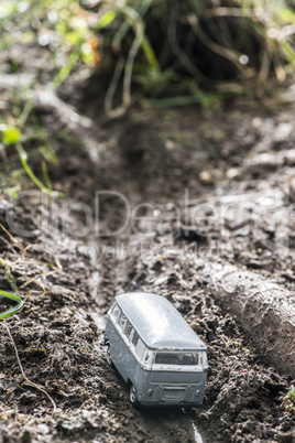 Vintage bus VW. Small metal toy in the nature.