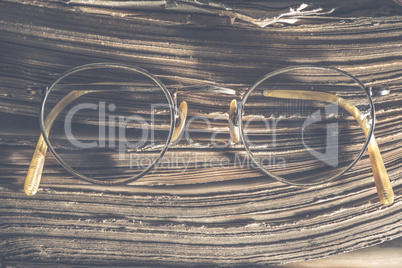 Old vintage round glasses and book