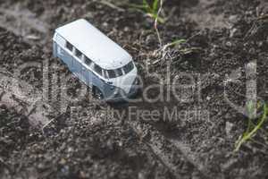Vintage bus VW. Small metal toy in the nature.