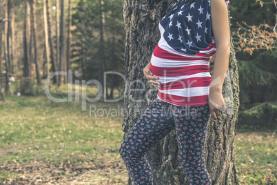 Pregnant woman in the forest