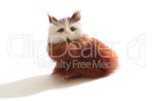 Cute fluffy toy kitten isolated on white background