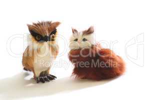 Pair of cute fluffy toys: kitten and owl, isolated on white background