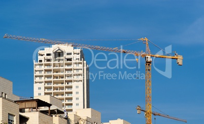 Lifting crane and apartment building under construction
