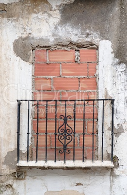 Old balcony door blocked by brick wall